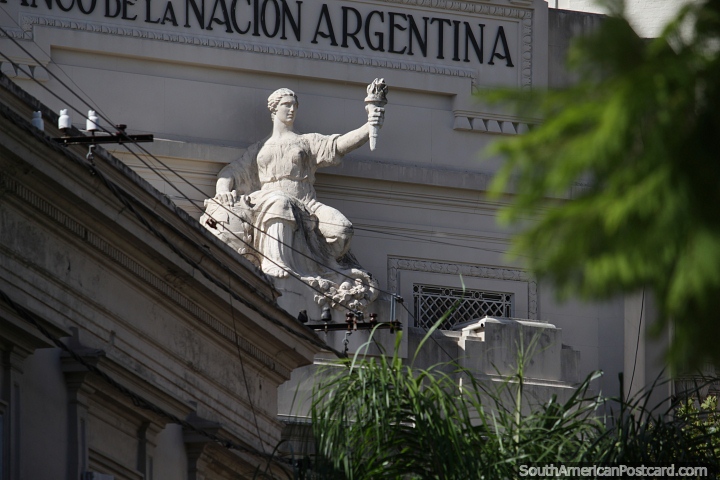 Monument holding a flame at the bank building in Concordia. (720x480px). Argentina, South America.