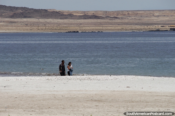 People walk along the sands of English Bay (Bahia Inglesa) in Caldera. (720x480px). Chile, South America.