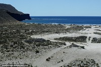 Rugged coastline and deep blue sea between Comodoro Rivadavia and Caleta Olivia.