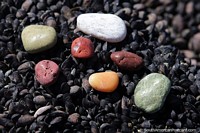 Collect smooth colorful rocks on the beach in Caleta Olivia.