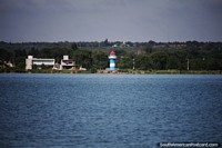 Blue, white and red lighthouse on the opposite side of the lagoon from the city in Santa Rosa.