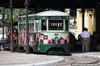 Trams with seating inside and out for city tours in Santos.