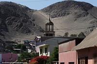 Old church tower with a backdrop of rocky mountains in Copiapo.