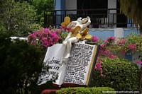 Memorial with an angel, butterflies and large book to a famous local of Aracataca - Gabriel Garcia Marquez (1927-2014), author.