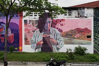 Lady in her jacket beside the river, street mural in Honda.