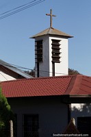 Church tower and red roof in the center of Obligado.