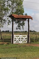 Rural property gate with roof and lighting around Valle Apua.