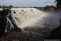 Powerful waterfalls over rocks into El Danto Lagoon at La Llovizna Park, Ciudad Guayana.